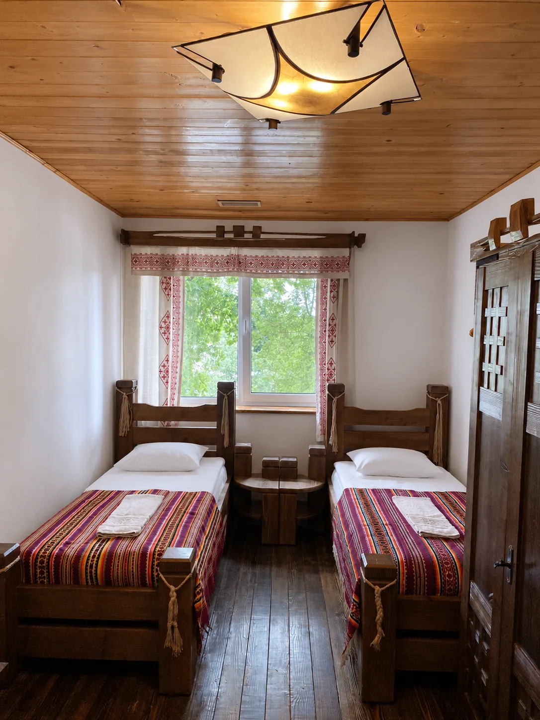 Two single beds in the triple room under the window