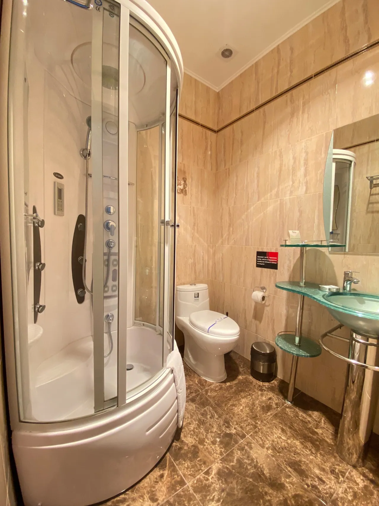 Private bathroom of the attic room with a shower cubicle