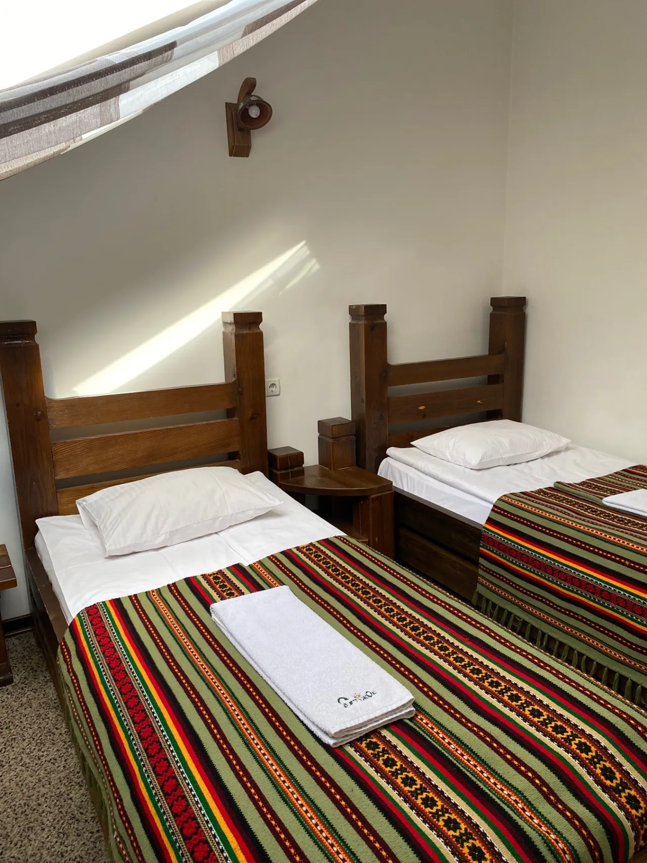 Attic room with two beds and air conditioning: two single beds with Bukovynian woven throws