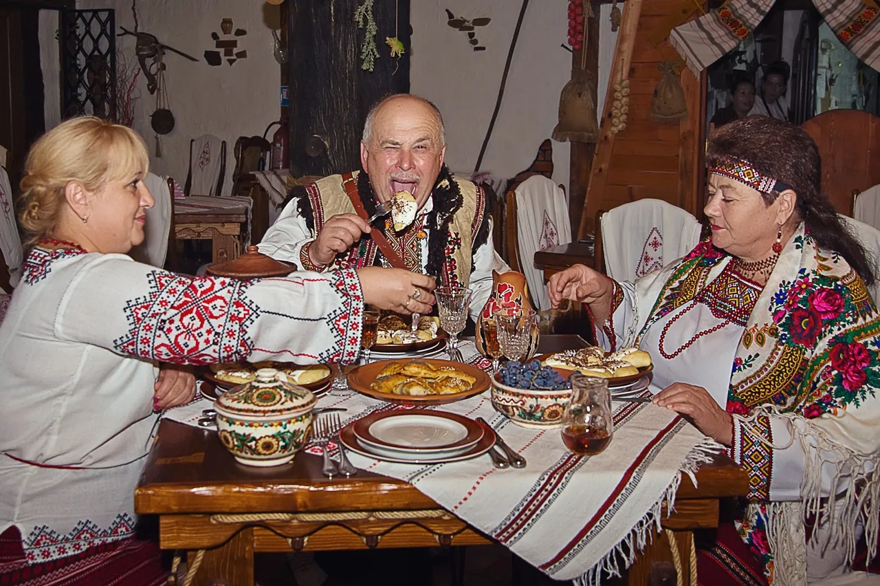 Guests in embroidered shirts at a table with varenyky at the Stizhok restaurant