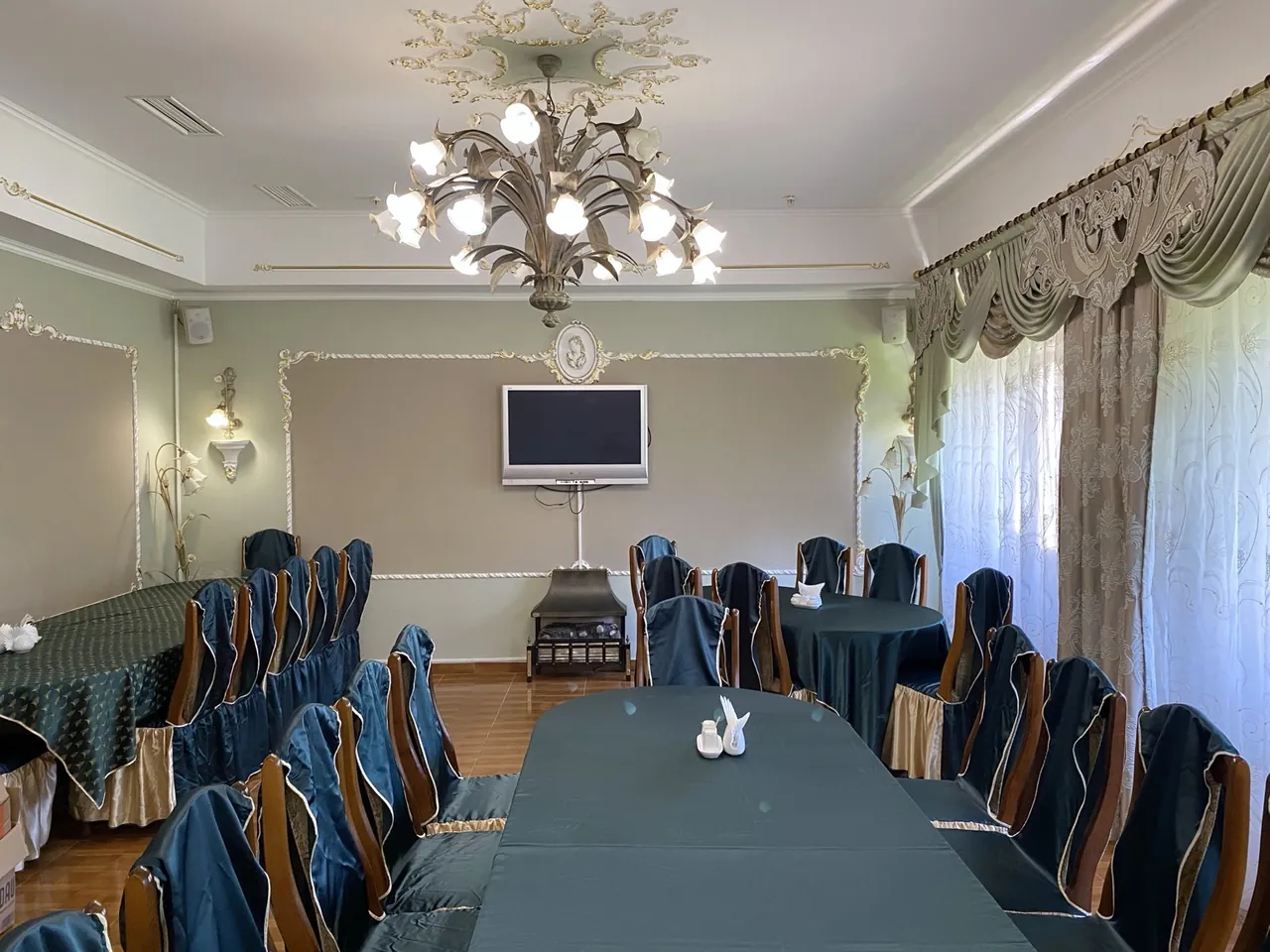 Stizhok's European Hall with a chandelier and set tables